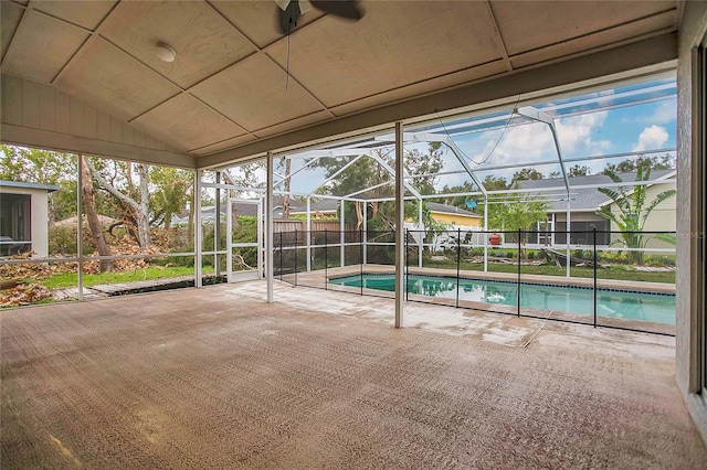 view of swimming pool featuring a patio area and glass enclosure