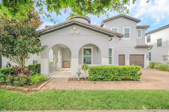 mediterranean / spanish-style home featuring a garage