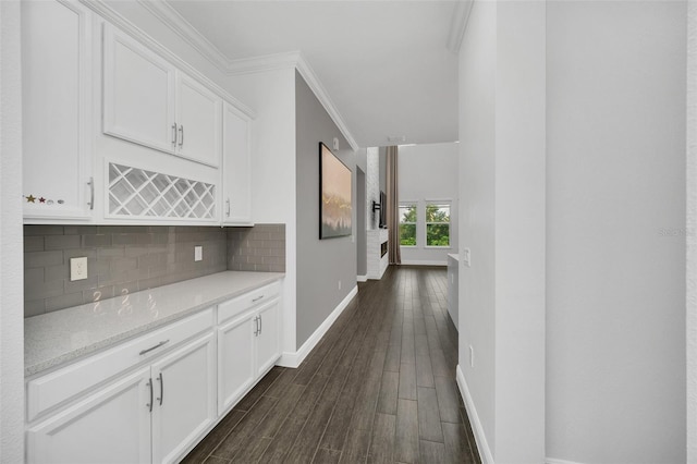 hall with ornamental molding and dark hardwood / wood-style flooring