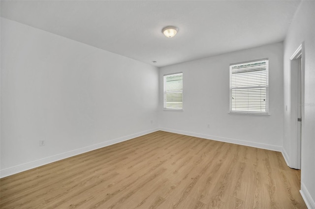 spare room with light hardwood / wood-style floors