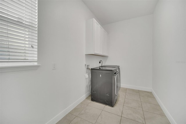 laundry room featuring washer hookup, cabinets, light tile patterned floors, and hookup for an electric dryer