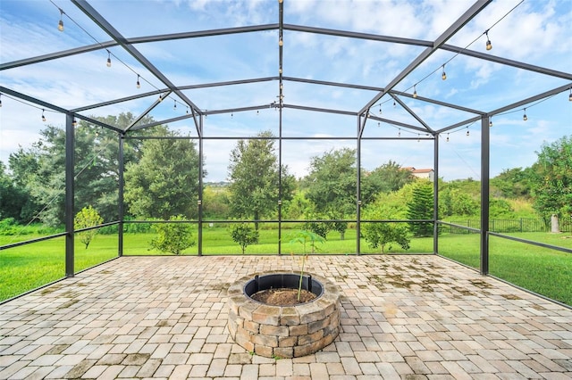 view of patio / terrace with a lanai and an outdoor fire pit