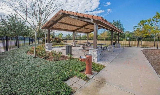 view of community featuring a lawn and a patio area