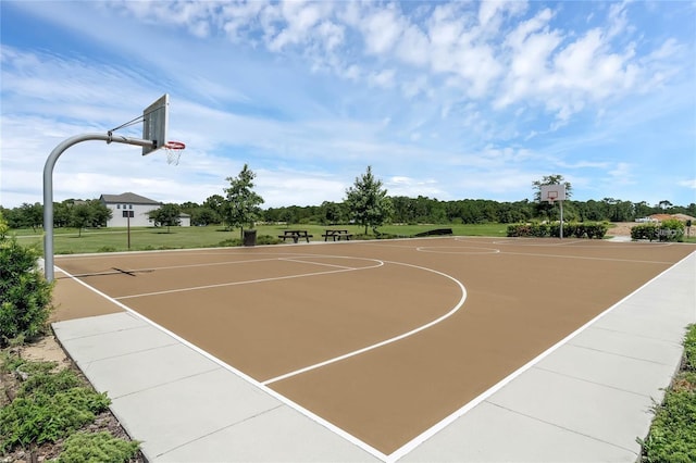 view of basketball court with a yard