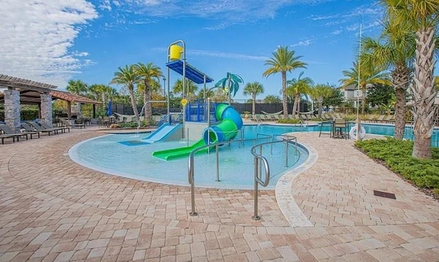 view of pool with a patio, a pergola, and a water slide