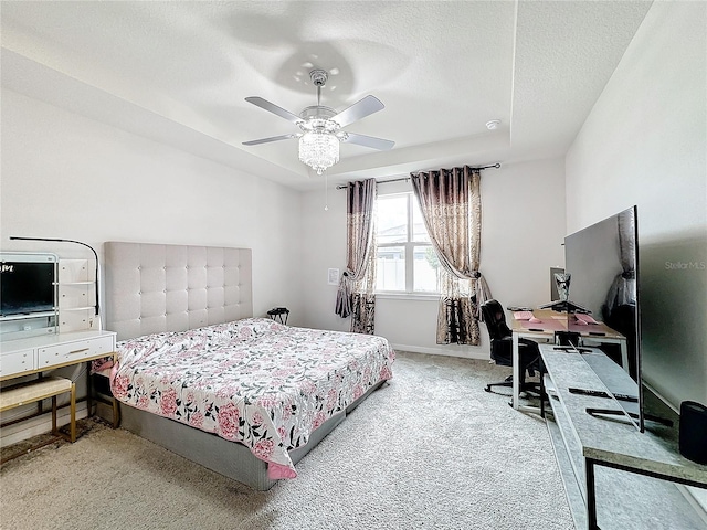 carpeted bedroom featuring a textured ceiling and ceiling fan