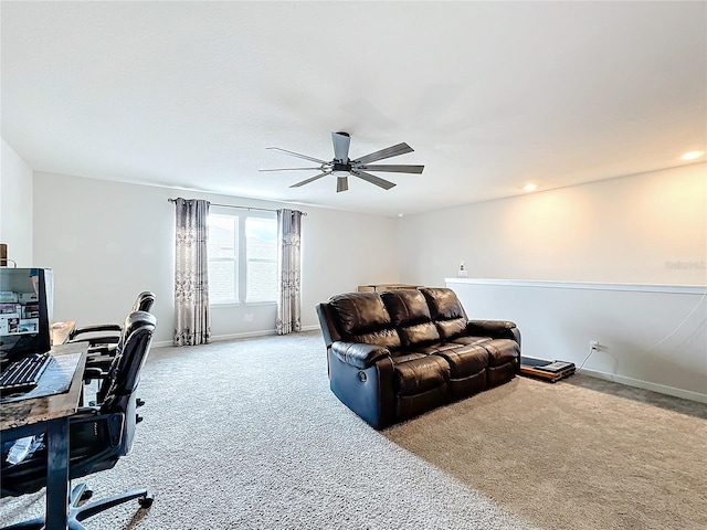 carpeted office space featuring ceiling fan