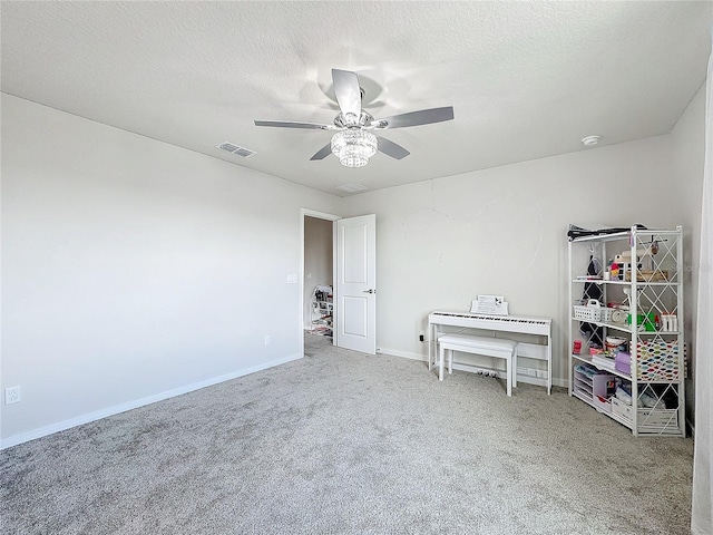 interior space with carpet floors, a textured ceiling, and ceiling fan