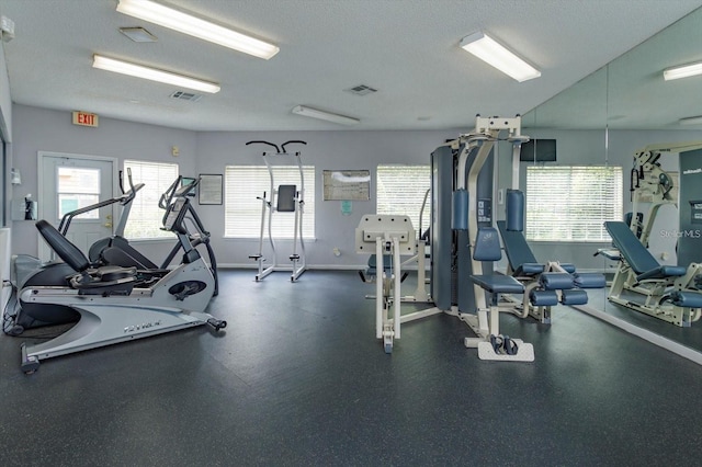 workout area featuring a textured ceiling