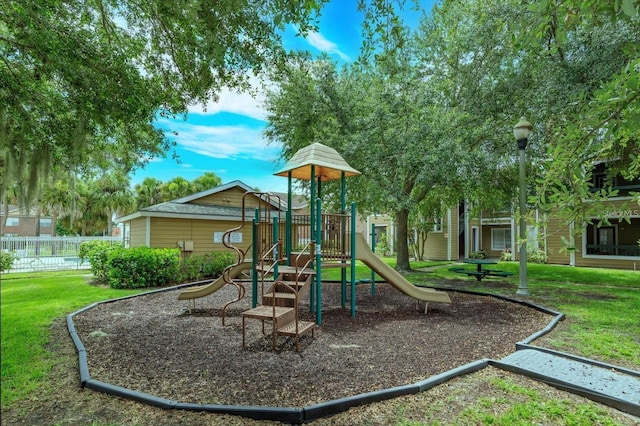 view of playground with a lawn