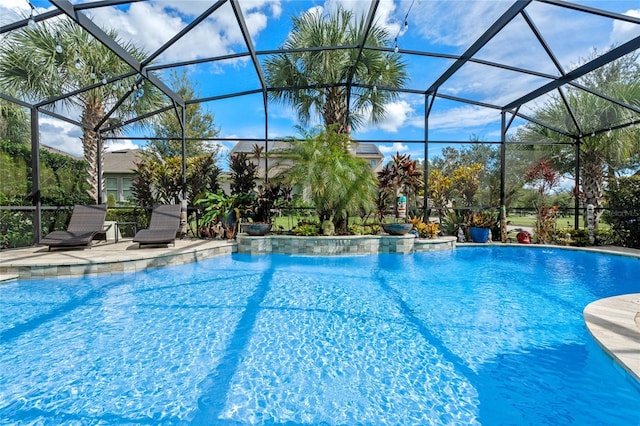 view of swimming pool featuring glass enclosure and a patio area