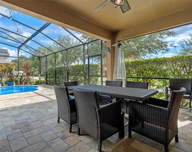 view of patio / terrace featuring ceiling fan and glass enclosure