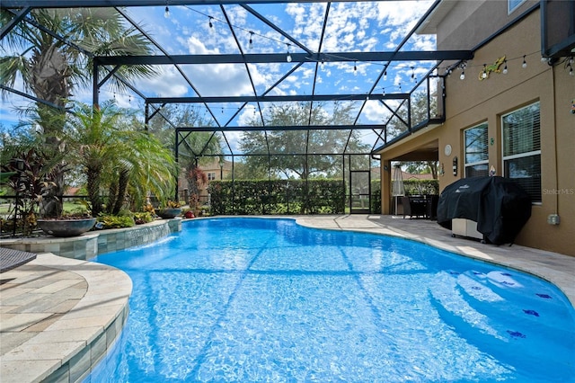 view of pool featuring grilling area, a lanai, and a patio area