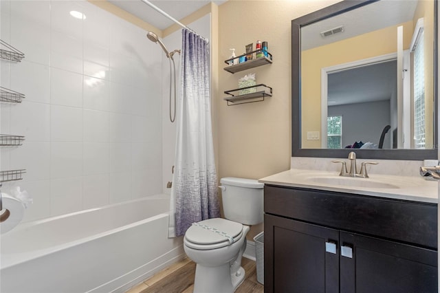 full bathroom with vanity, toilet, shower / bath combo with shower curtain, and hardwood / wood-style floors