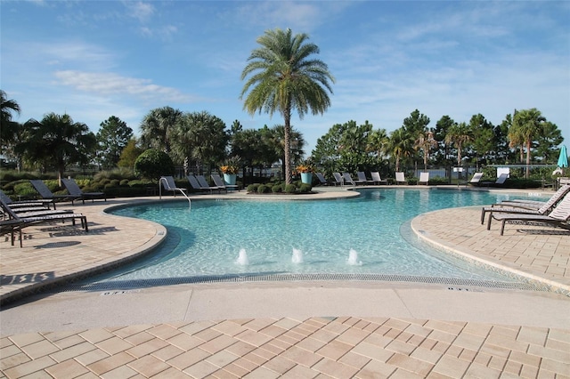 view of pool with a patio area and pool water feature