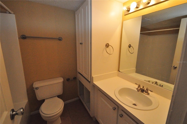 bathroom featuring a textured ceiling, tile patterned flooring, vanity, and toilet