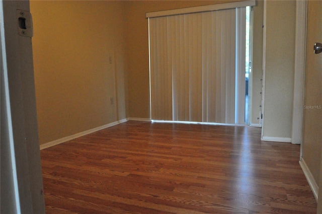 unfurnished room featuring dark hardwood / wood-style flooring