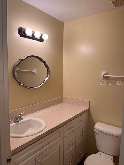 bathroom with vanity and toilet