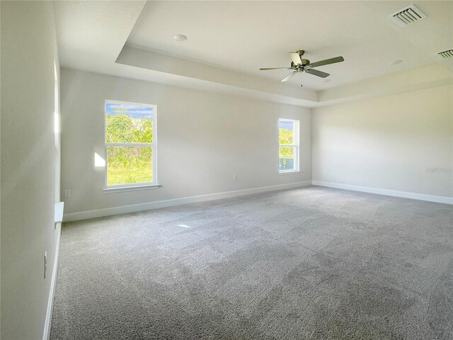 4298 Sagefield Dr, Harmony, FL 34773 - carpeted empty room with a tray ceiling, baseboards, and ceiling fan