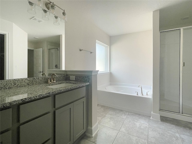 bathroom featuring tile patterned floors, independent shower and bath, and vanity