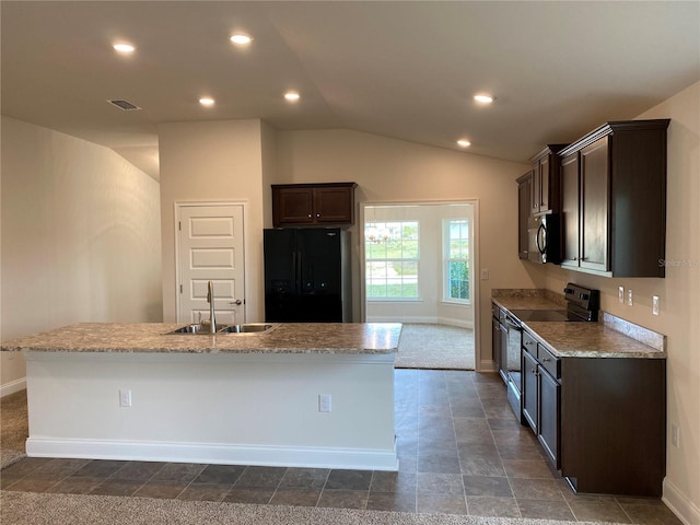 4306 Sagefield Dr, Harmony, FL 34773 - kitchen featuring appliances with stainless steel finishes, a sink, baseboards, an island with sink, and dark brown cabinetry