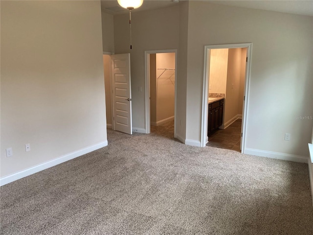 4306 Sagefield Dr, Harmony, FL 34773 - unfurnished bedroom featuring a walk in closet, carpet, a closet, baseboards, and ensuite bathroom