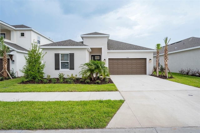 view of front of property featuring a front yard and a garage