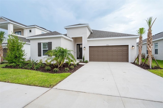 view of front of home with a front lawn and a garage