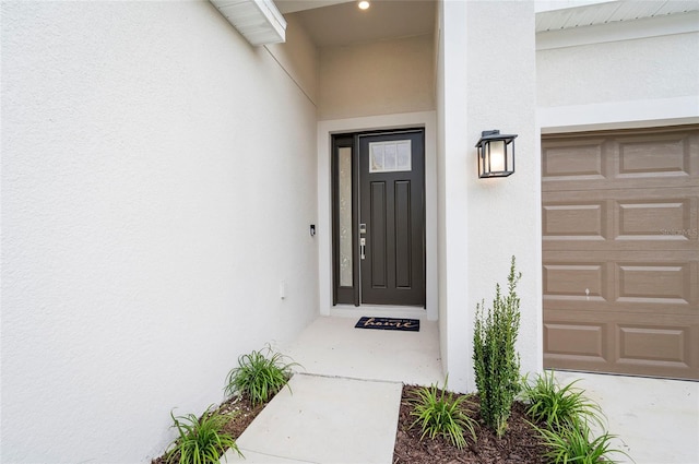 doorway to property with a garage