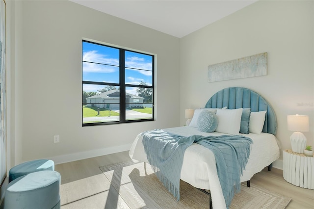 bedroom with light wood-type flooring and radiator heating unit