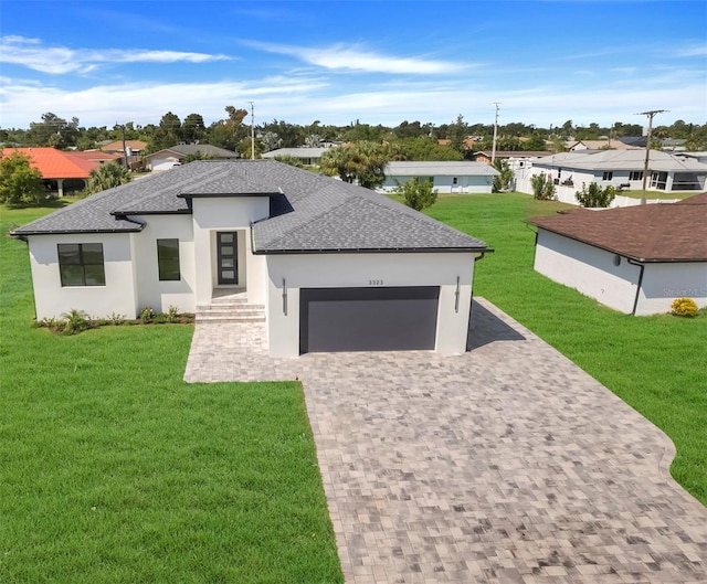 view of front of home with a garage and a front yard