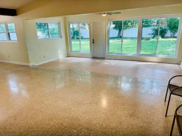 spare room with a healthy amount of sunlight and ceiling fan