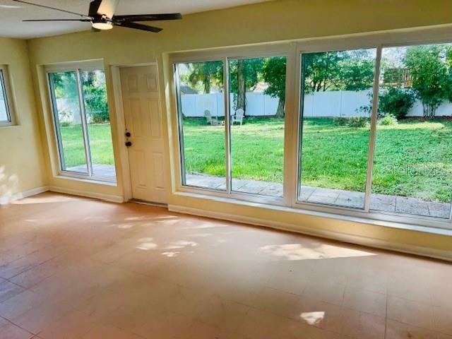 doorway to outside featuring ceiling fan