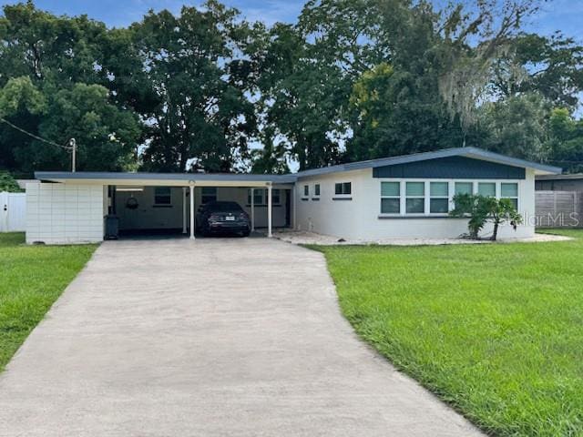 single story home with a carport and a front lawn