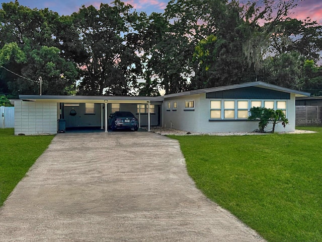 single story home with a yard and a carport