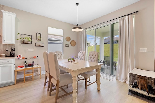 dining area with light hardwood / wood-style flooring and a wealth of natural light