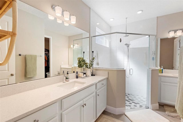 bathroom featuring tile patterned flooring, vanity, and a shower with shower door