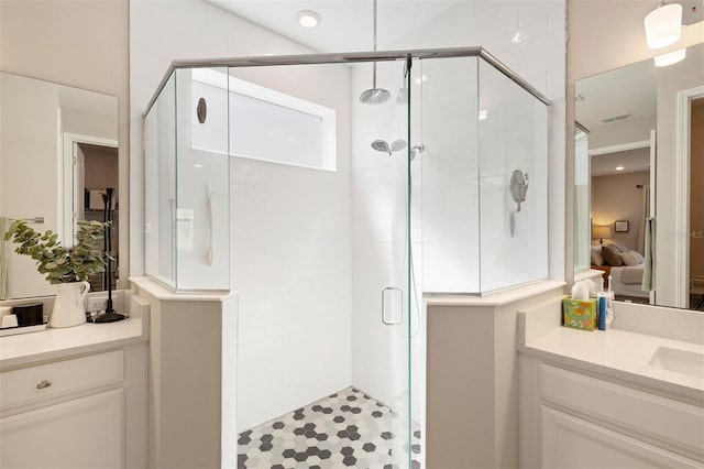 bathroom featuring vanity and a shower with door