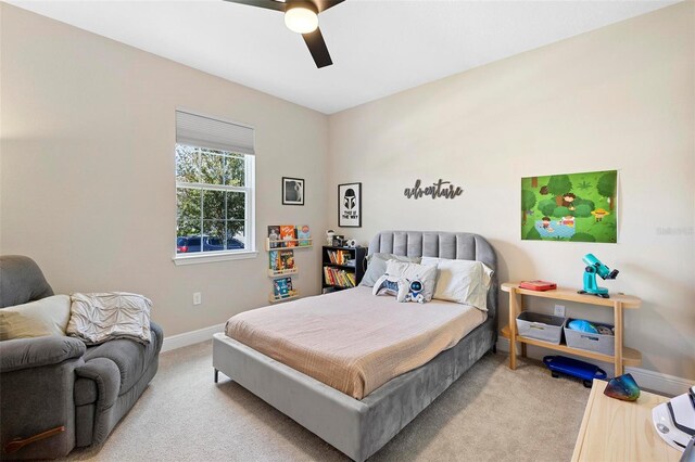 bedroom with ceiling fan and light carpet