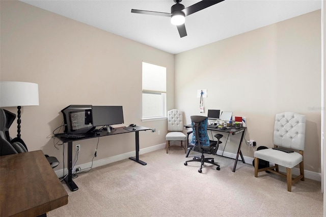 office space featuring light carpet and ceiling fan