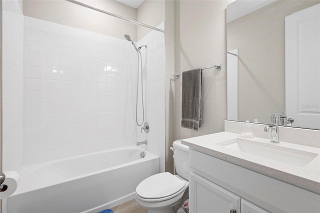 full bathroom with tiled shower / bath combo, vanity, and toilet