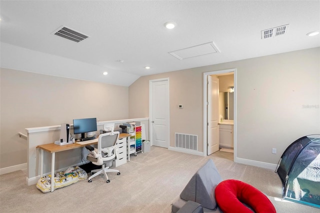 carpeted office space featuring lofted ceiling