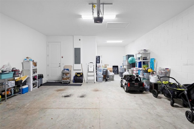 garage with a garage door opener and electric panel