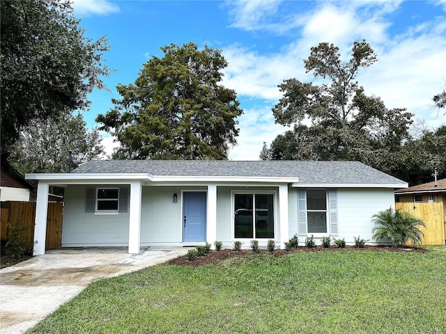 ranch-style house featuring a front lawn and a carport