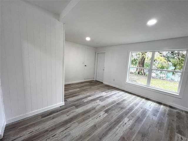 empty room with dark wood-type flooring