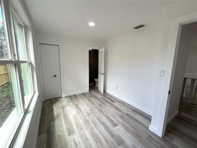 unfurnished bedroom featuring a closet and light hardwood / wood-style flooring