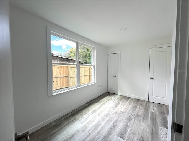 spare room featuring light hardwood / wood-style flooring