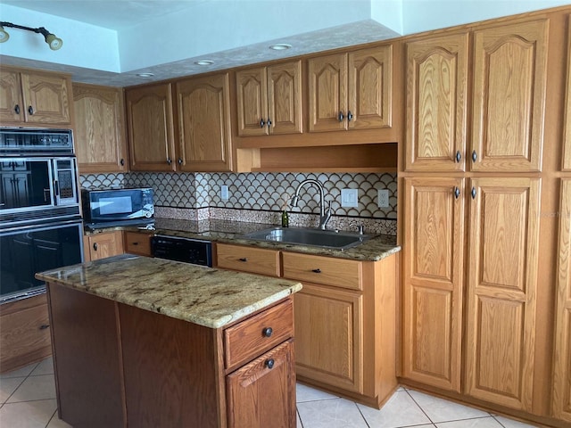 kitchen with backsplash, light tile patterned floors, black appliances, stone counters, and sink