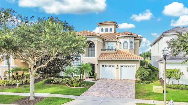 mediterranean / spanish-style house with a front yard and a garage