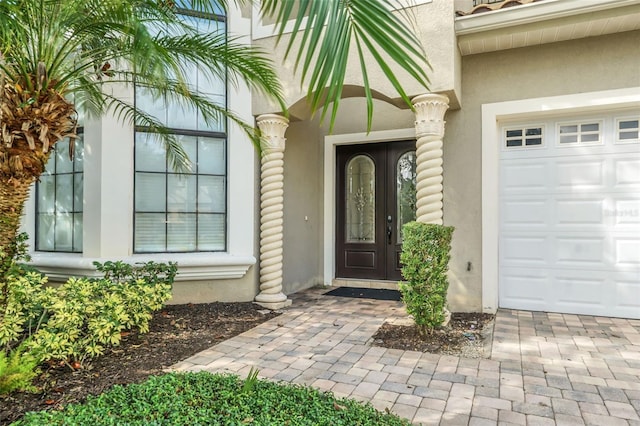 view of exterior entry with a garage